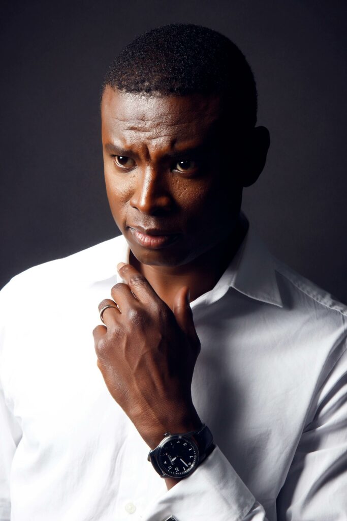Portrait of a thoughtful man in a crisp white shirt with a serious expression.